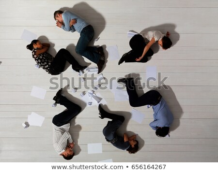 Foto stock: Business Men And Women Asleep On Floor