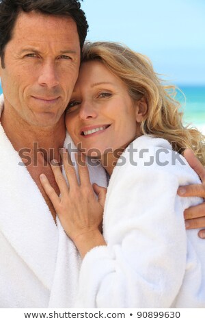 Foto stock: Couple In Bathrobes On The Beach
