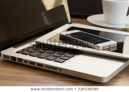 Modern Phone With Touchscreen On Laptop Keyboard Foto d'archivio © Neirfy