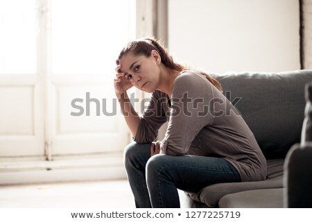 Сток-фото: Worried Young Woman Sitting In Living Room