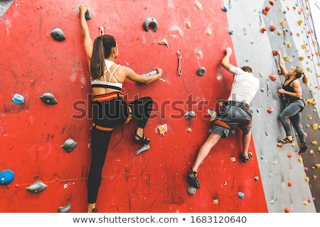 Zdjęcia stock: Young Man Exercising At Indoor Climbing Gym