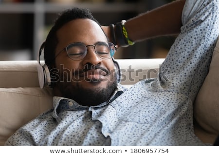 Stock fotó: Close Up Of Man With Earphones Listening To Music