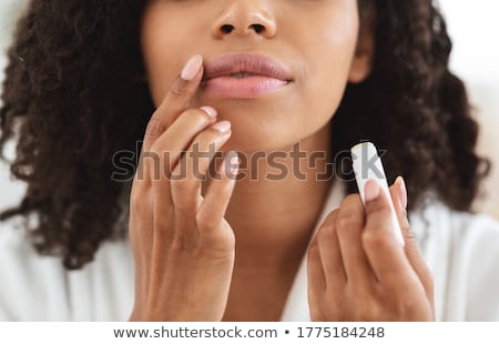 [[stock_photo]]: Woman Applying Lipstick On Lips Natural Beauty