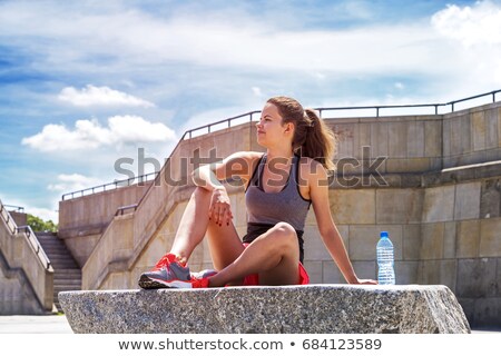 Athlete Woman Sitting After Sport Exercising On The Rocks By The ストックフォト © Wisiel