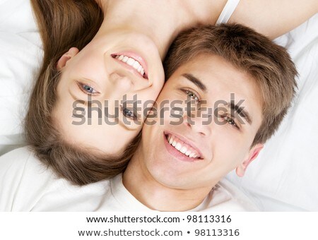 Stok fotoğraf: Portrait Of A Pretty Young Couple Lying Together