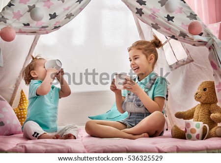 Сток-фото: Little Girl Playing Tea Party In Kids Tent At Home