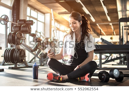 Stock photo: Young Sporty Woman Resting And Listen Music On Mobile Phone Afte