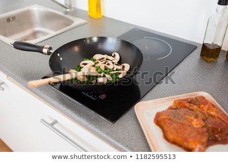 Сток-фото: Close Up Of Food In Frypan On Cooking Panel