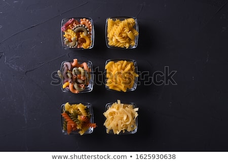 Stock photo: Assortment Mix Of Traditional Macaroni On Dark Brown Wooden Board As Decorative Paste Background