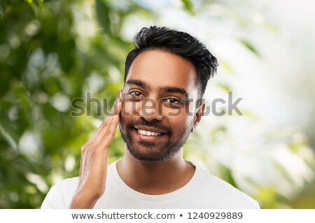 Stock fotó: Smiling Indian Man Touching His Face