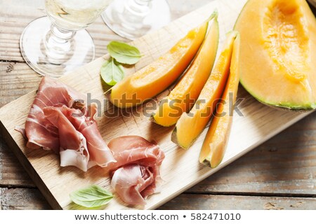 Stockfoto: Slices Of Cantaloupe Melon And Prosciutto Ham Shallow Dof