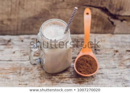 Stockfoto: Drink From Carob And Kerob Powder In A Wooden Spoon