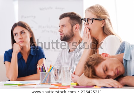 [[stock_photo]]: Boring Presentation Group Of Young Business People In Smart Casual Wear Looking Bored While Sitting