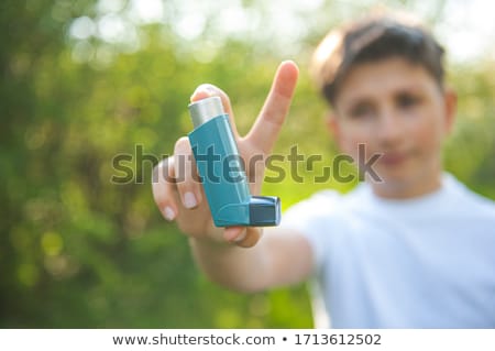 Stok fotoğraf: A Boy Having A Asthma Problem Outside