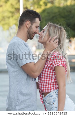 [[stock_photo]]: Head And Shoulders Of A Young Couple Embracing In The Sunshine