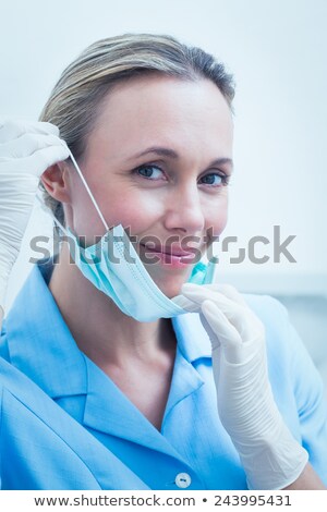 Foto stock: Dentist In Surgical Mask Smiling At Camera