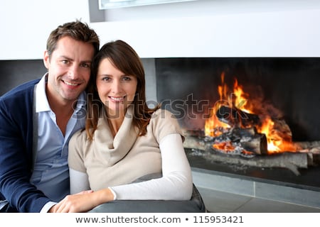 [[stock_photo]]: Ouple, · séance, · dans, · salle · de · séjour, · par, · cheminée, · sourire