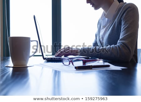 Stockfoto: Close Up Of A Smiling Woman Typing On Laptop Computer