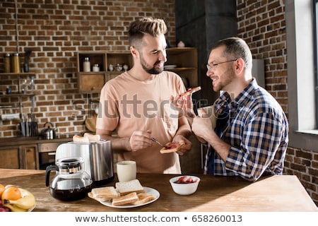 Сток-фото: Gay Couple Eating Breakfast At Home In The Morning