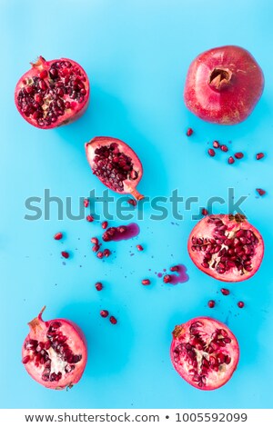 Imagine de stoc: Half Pomegranate Fruit On Blue Background Fresh Red Ripe