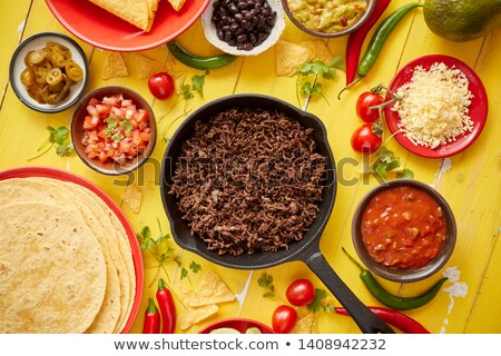 [[stock_photo]]: Various Fresh And Tasty Ingredients For Chilli Con Carne With Meat On Iron Pan