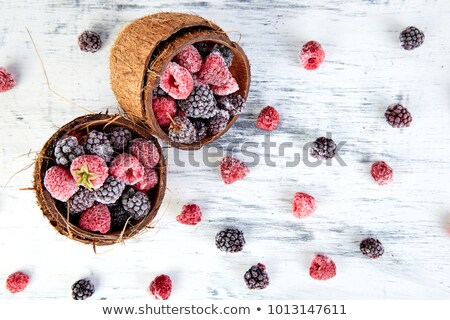 Stock photo: Frozen Black And Red Raspberries In Coconut Bowl