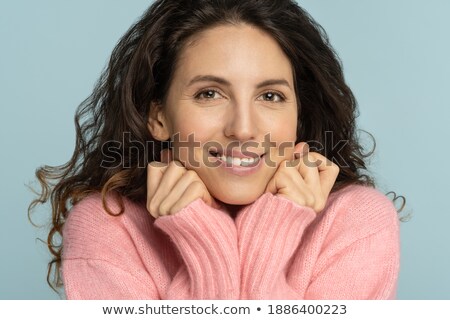 Stock foto: Pleased Lovely Woman With Make Up Keeps Hands Under Chin Has Brown Hair Looks Happily At Camera