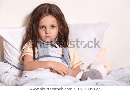 Foto stock: Portrait Of A Sick Child Being Checked With A Thermometer By A D
