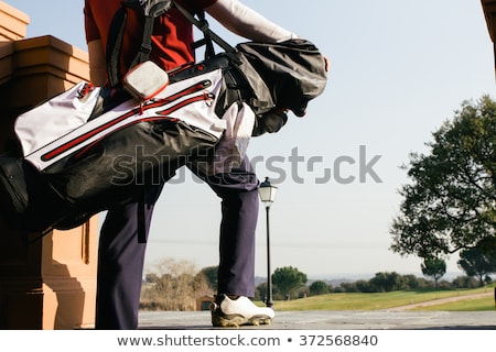 Foto stock: Golfer Carrying His Equipment