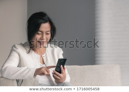 Foto stock: A Senior Asian Businesswoman Texting
