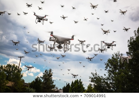 Foto d'archivio: Dozens Of Drones Swarm In The Cloudy Sky