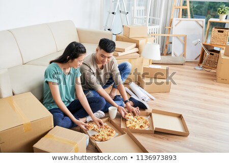 Сток-фото: Cheerful Couple Eating Pizza On Moving Day