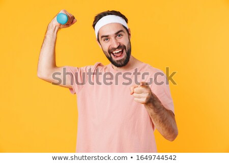 Foto stock: Image Of Muscular Athletic Young Man Having Fun And Lifting Dumb