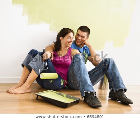 Imagine de stoc: Couple In Front Of Painted Wall