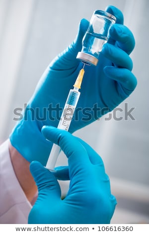 Сток-фото: Woman Filling Medicine In Syringe