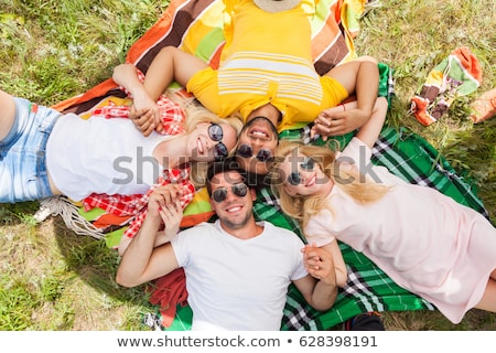 Foto stock: Teenage Girls In Sunglasses On Picnic Blanket