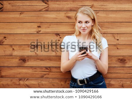 Сток-фото: Woman In Sunglasses Against The Background Of A Wooden Wall