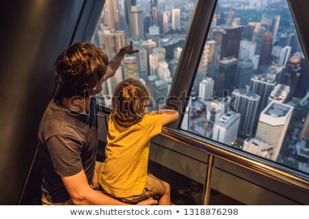 [[stock_photo]]: Dad And Son Are Looking At Kuala Lumpur Cityscape Panoramic Vie