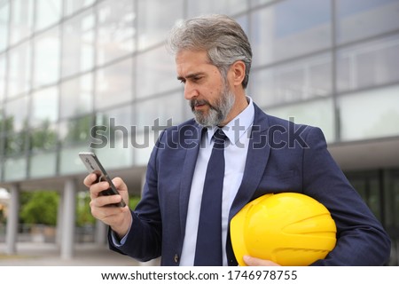 Foto d'archivio: Architect On Building Site Looking At House Plans