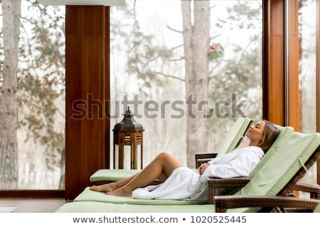 Stok fotoğraf: Pretty Young Woman Relaxing On The Poolside