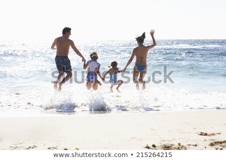 ストックフォト: Rear View Of Family Enjoying On The Beach