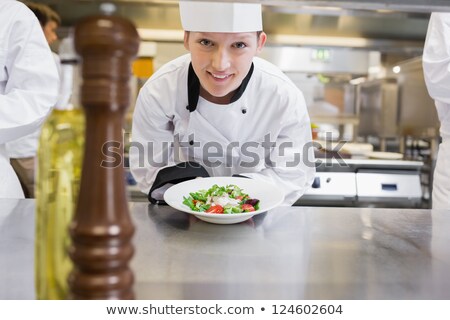 Сток-фото: Group Of Chefs Holding Plate Of Prepared Food In Kitchen At Hotel