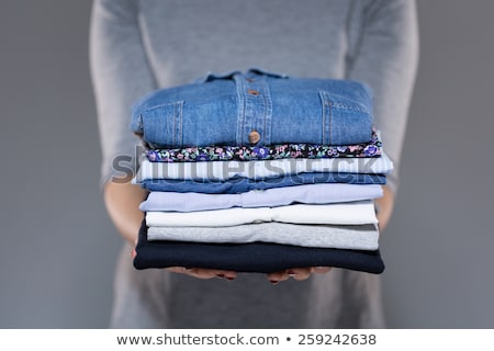 Foto stock: Housewife Folding Clothes