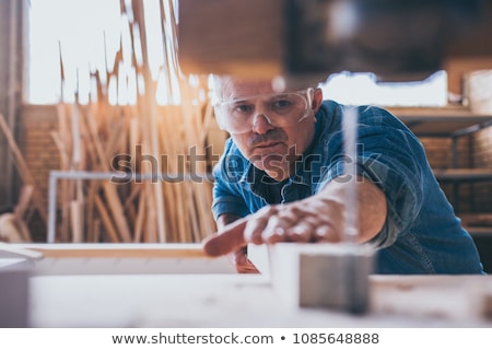 Stock photo: A Mature Carpenter With A Circular Saw
