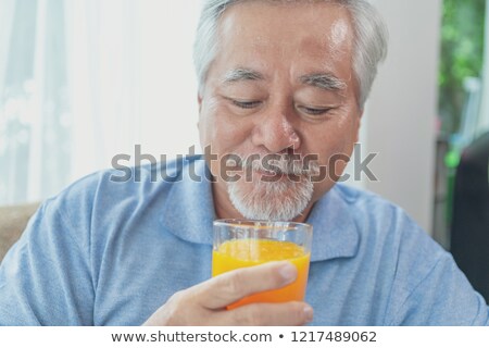 Stock photo: Man Holding Glass Of Juice
