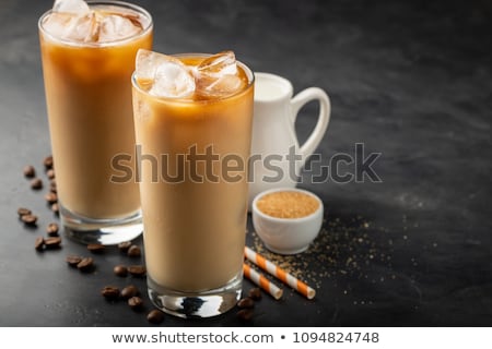 Foto stock: Ice Coffee In A Tall Glass And Coffee Beans