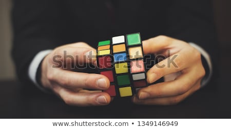 Foto stock: Businessman Trying To Solve Rubik Cube