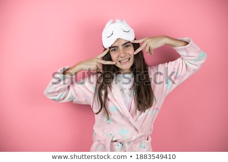 Foto d'archivio: Two Cheerful Girls Wearing Pajamas Standing