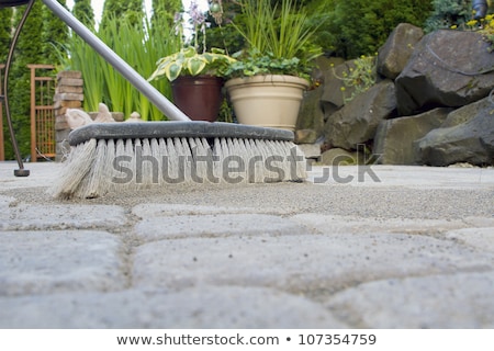 Foto d'archivio: Broom Sweeping Sand Into Pavers Low View