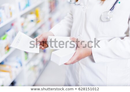 Сток-фото: Happy Pharmacist Handing Paper To A Customer